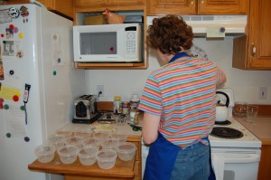 LDS woman works in her kitchen to make freezer jam